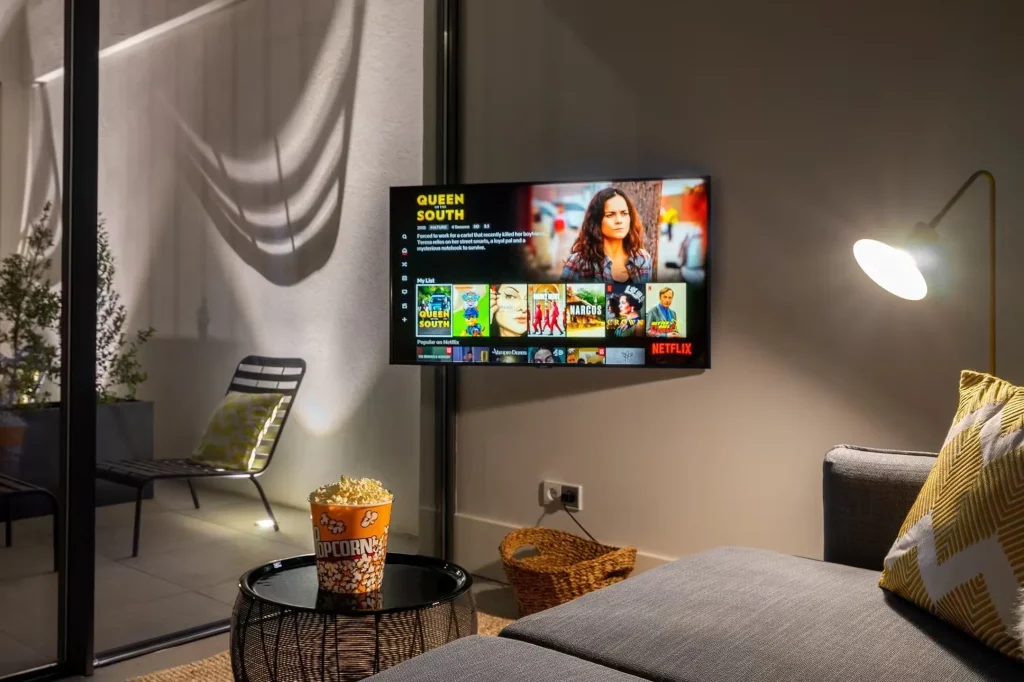 A living room at 14 Acres with Netflix on the television in the evening
