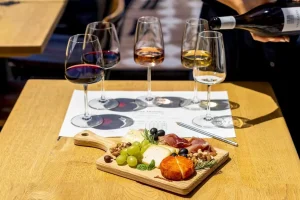 Wine tasting with a charcuterie board featuring cheeses, grapes, nuts, olives, and cured meats at 14 Acres, Clipston.