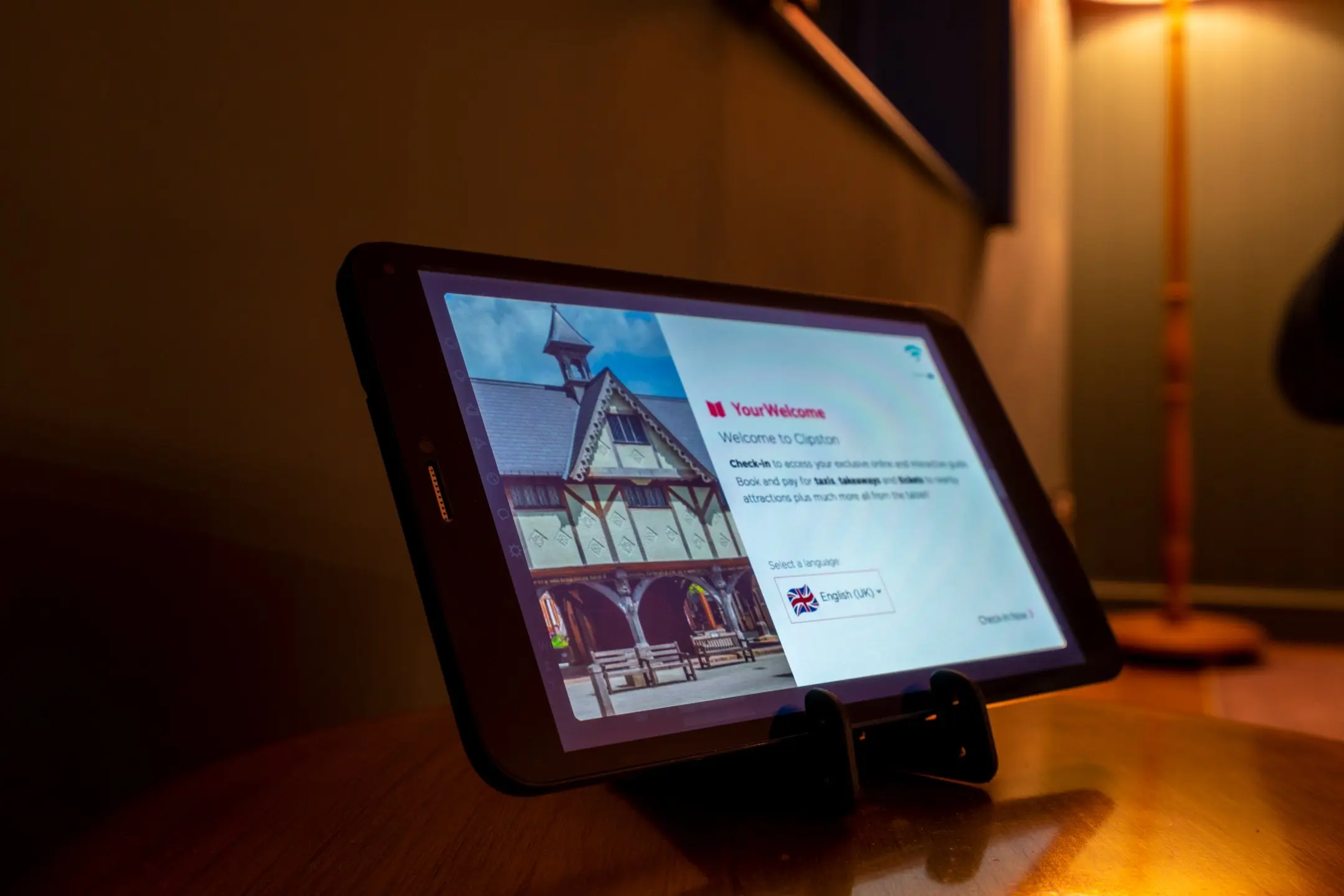 Tablet displaying the "YourWelcome" digital concierge service for 14 Acres, showing a historic building and a welcome message