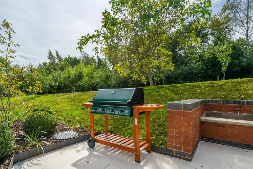 The gas barbecue in the outdoor kitchen garden at The Barn, 14 Acres