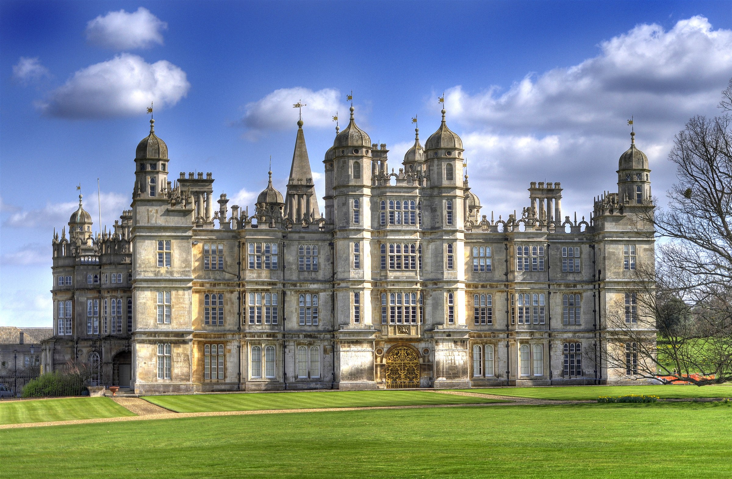 The west front of Burghley House near Stamford, an Elizabethan prodigy house with domed turrets and a gilded gateway