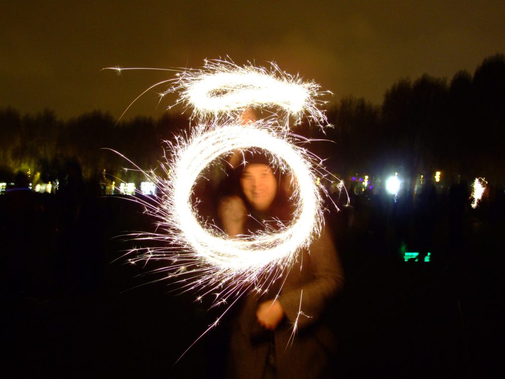 A sparkler drawn in circles of light at an outdoor Bonfire Night display