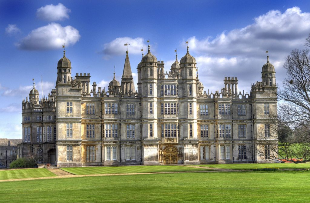 The Elizabethan west front of Burghley House near Stamford under a blue sky