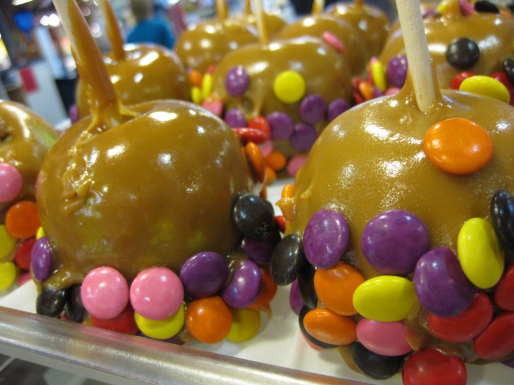 Toffee apples on sticks decorated with colourful chocolate sweets