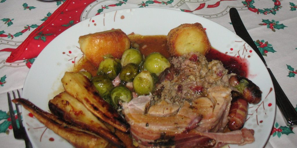 A British Christmas dinner of roast turkey, roast potatoes, parsnips, sprouts, pigs in blankets, stuffing and cranberry sauce